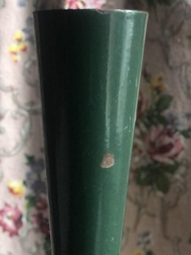 Tall metal florist’s vase close up