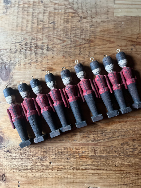 Group of 9 vintage wooden toy soldiers. Hand painted with red & black uniforms