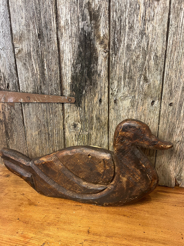 Oak carved duck board against rustic door