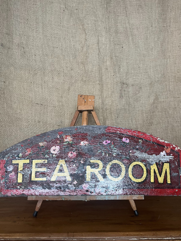 Antique Tea Room sign gold letters on red painted background with pink roses