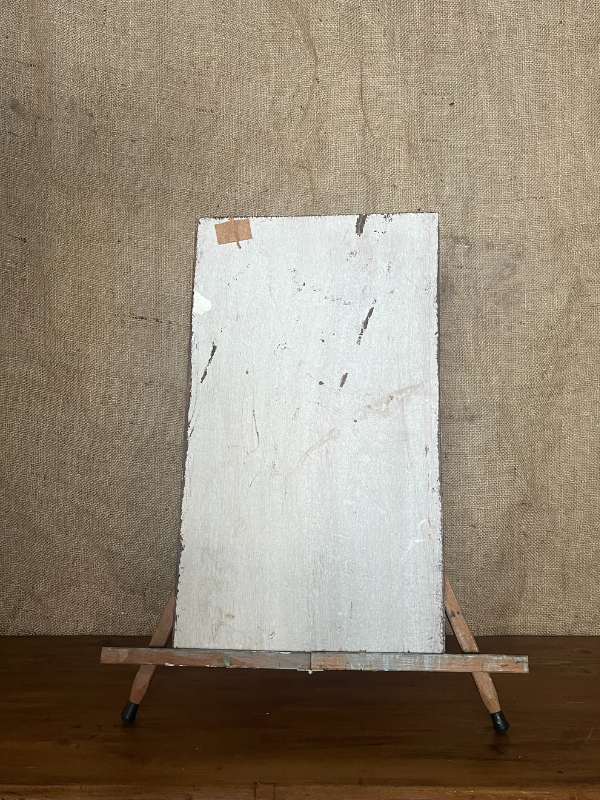 Back view of a small floral painting on white wooden board