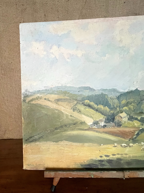 Corner shot of signature of Goddard painting of a country valley scene