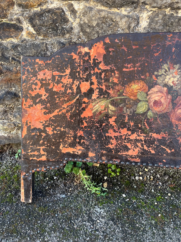 Left hand view of distressed & faded painted floral bouquet with pink on a brown leather background