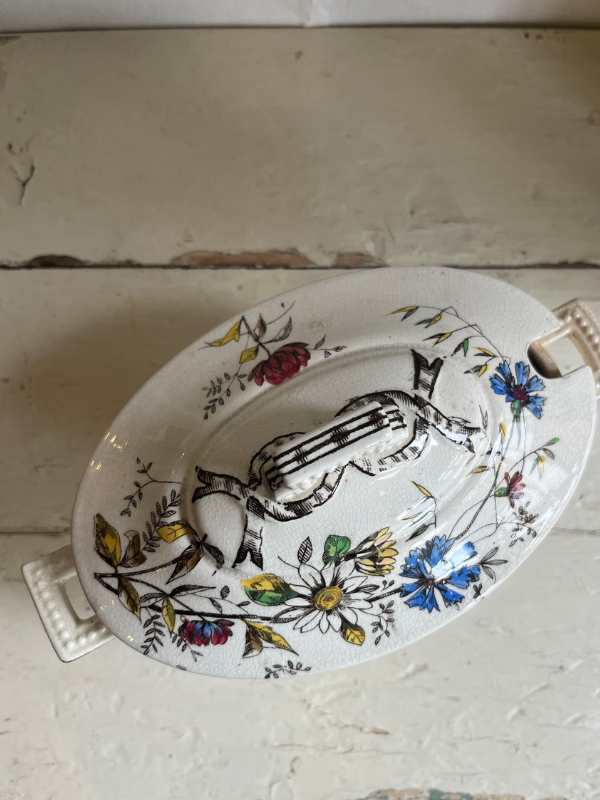 Vintage floral dish shot from above showing detail of painted lid