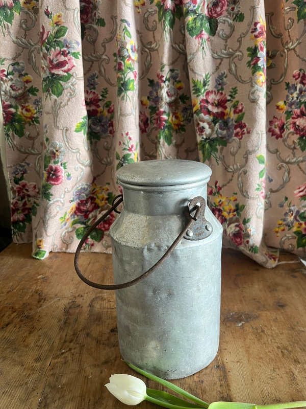 Side view of a metal milk churn