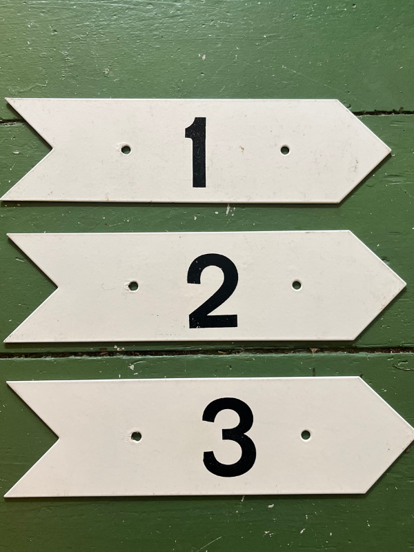 Vintage golf numbers 1 2 3 on a green wooden floor