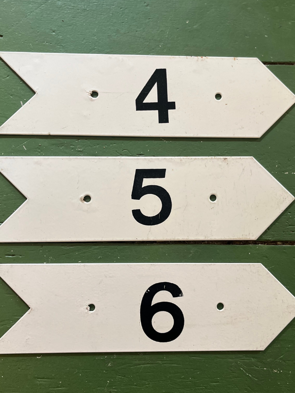 Vintage golf numbers 4 5 6 on a green wooden floor