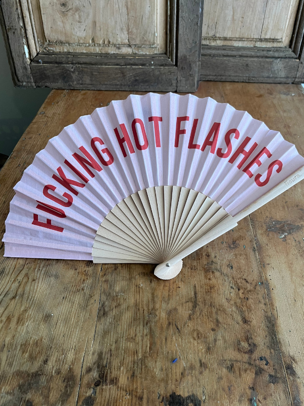 Close F.ing Hot Flashes fan on wooden table
