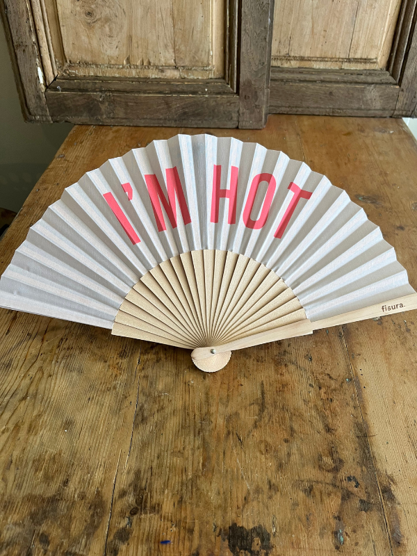 Front view of I'm Hot fan on wooden table