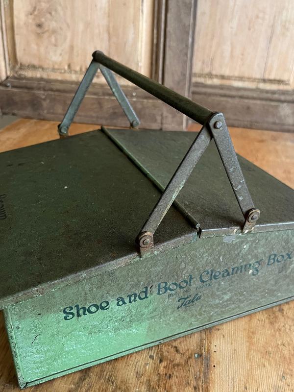 Reverse view of Tala green metal shoe cleaning box on a wooden table