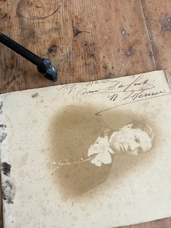 Reverse view of a sepia photo board of a Victorian lady showing handwritten inscription & artists fingerprints