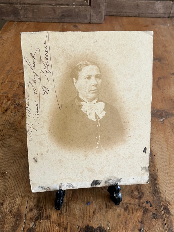 Reverse view of a sepia photo board of a Victorian lady