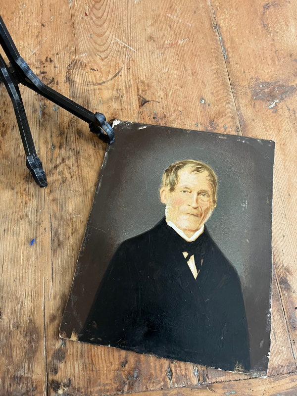 Small overpainted portrait of a Victorian gent on a wooden table