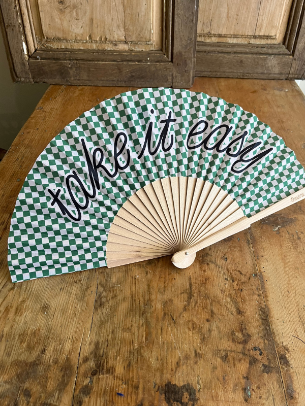 Take it Easy green gingham fan on wooden table