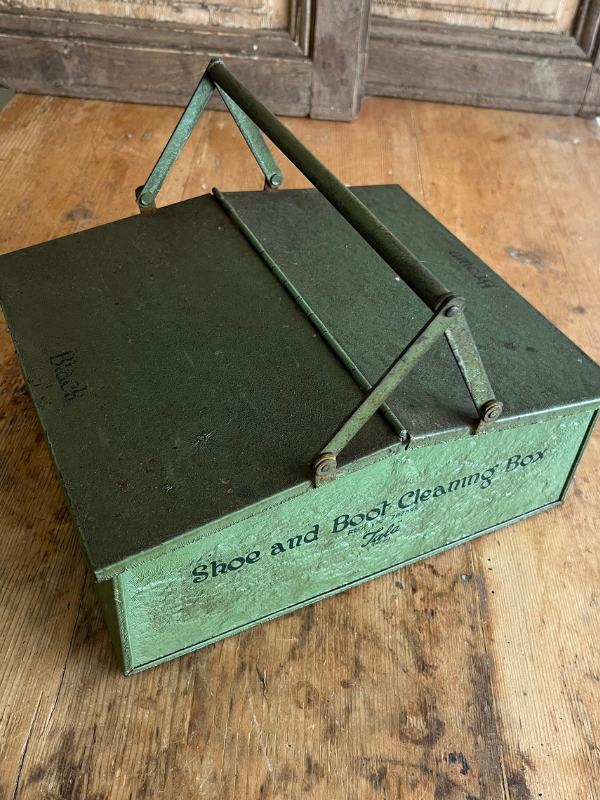 Top shot of Tala green metal shoe cleaning box on a wooden table
