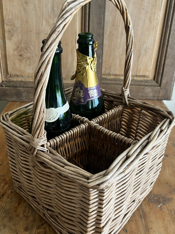 Vintage wicker bottle basket with bottles
