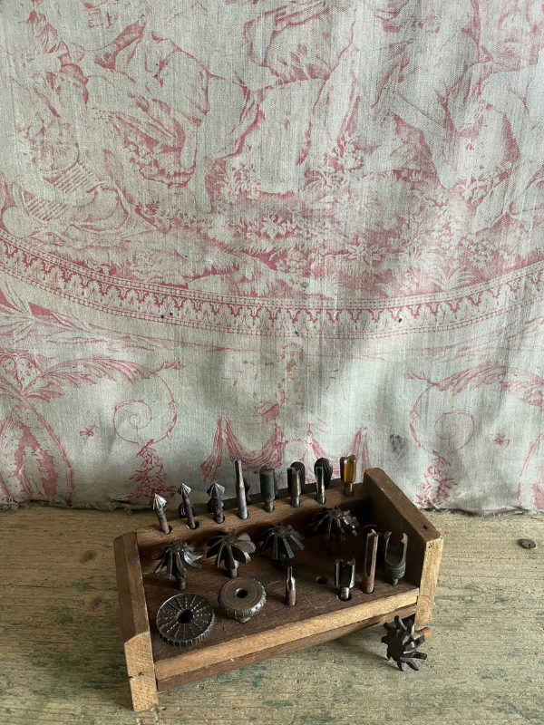lternative-view-of-a-decorative-tool-set-against-pink-toile-de-jouy-fabri