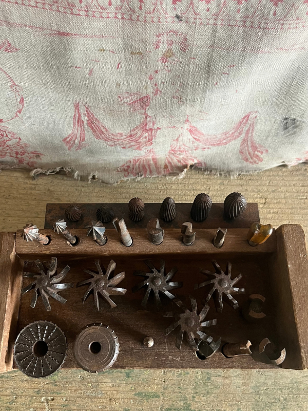 Vintage-tool-set-against-pink-toile-de-jouy-fabric
