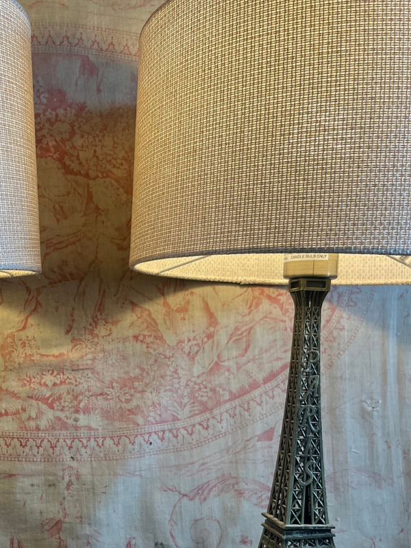Close up of Eiffel Tower lamp showing texture detail of the neutral coloured lampshade
