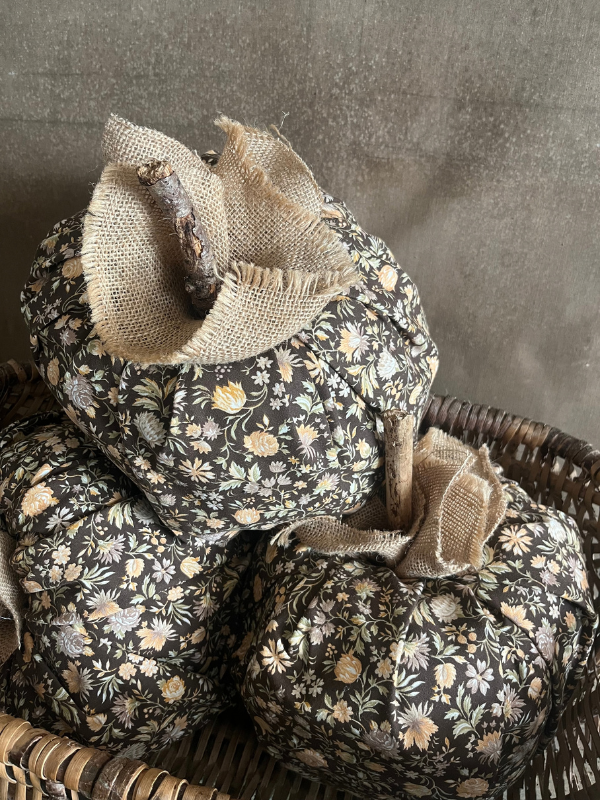 Side shot of large brown floral fabric pumpkins with hessian trim